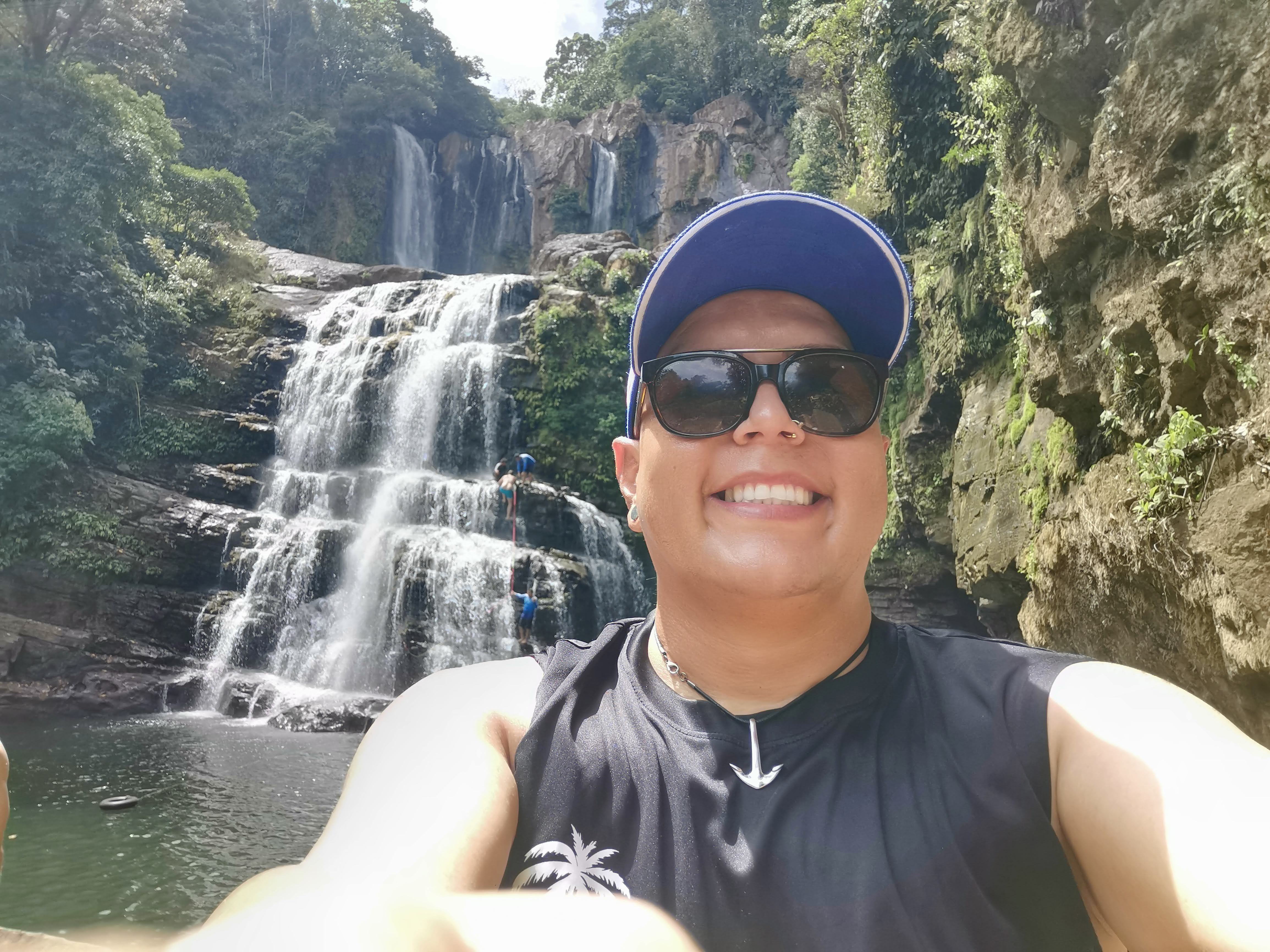 Sergio smiling at a Costa Rican waterfall