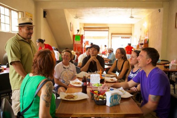 A food tour guide, from Vallarta Food ours, explains Mexican Cuisine to tourists in Puerto Vallarta.