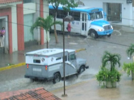 Sreets in downtown Puerto Vallarta are flooded with rain water.