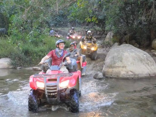 ATV tour crossing a river in Puerto Vallarta Mexico