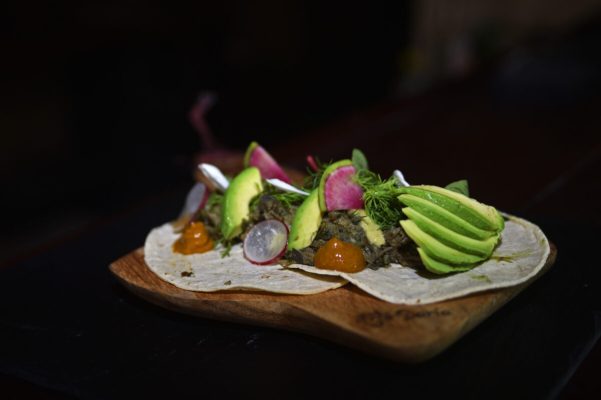 Beautiful plating of meat and veggies with a dark background
