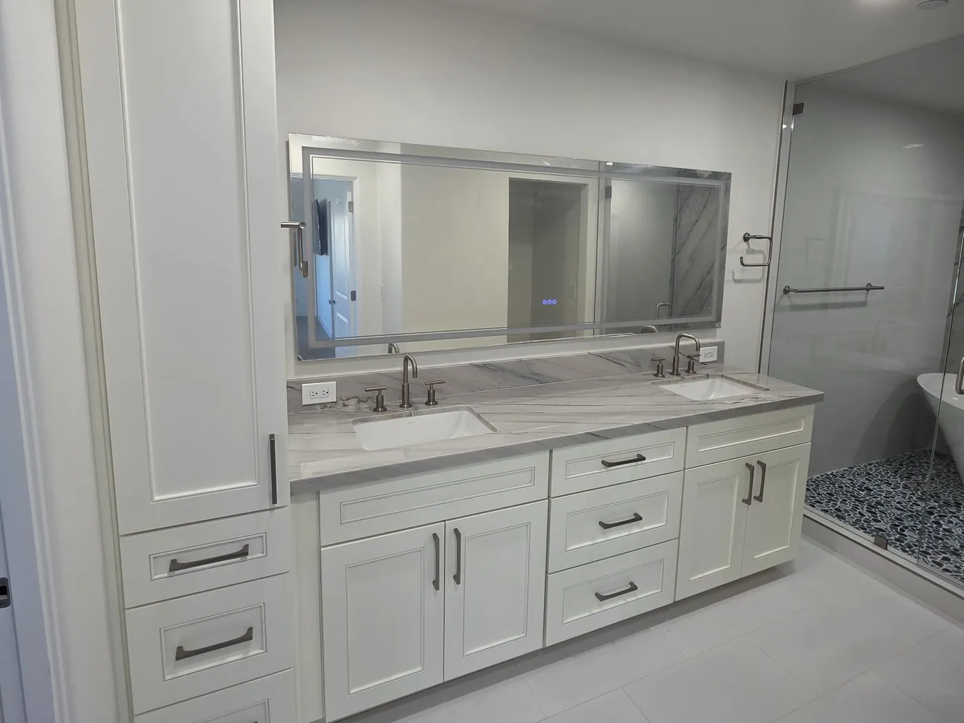 After: master bath with white shaker cabinets and a stone vanity top