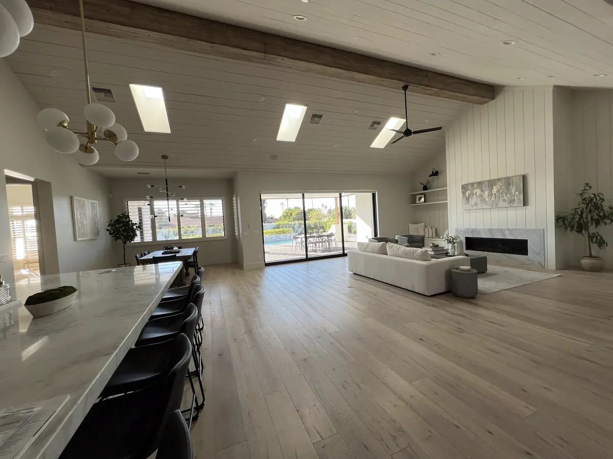 Wide-plank floor through an open great room and kitchen