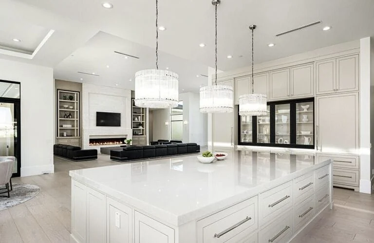 Chef's kitchen with a white quartzite island, custom cabinetry and light oak floors in a Paradise Valley estate