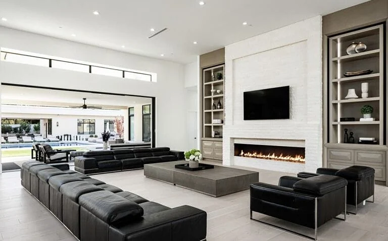 Great room with built-in shelving and light oak floors