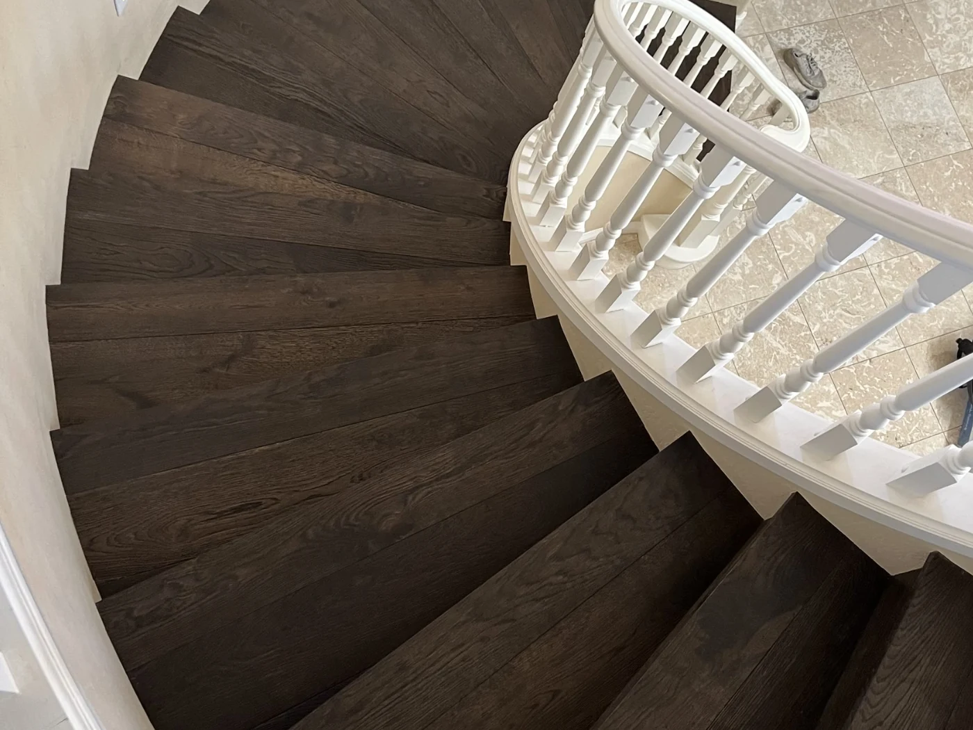 After: curved staircase with dark wood treads