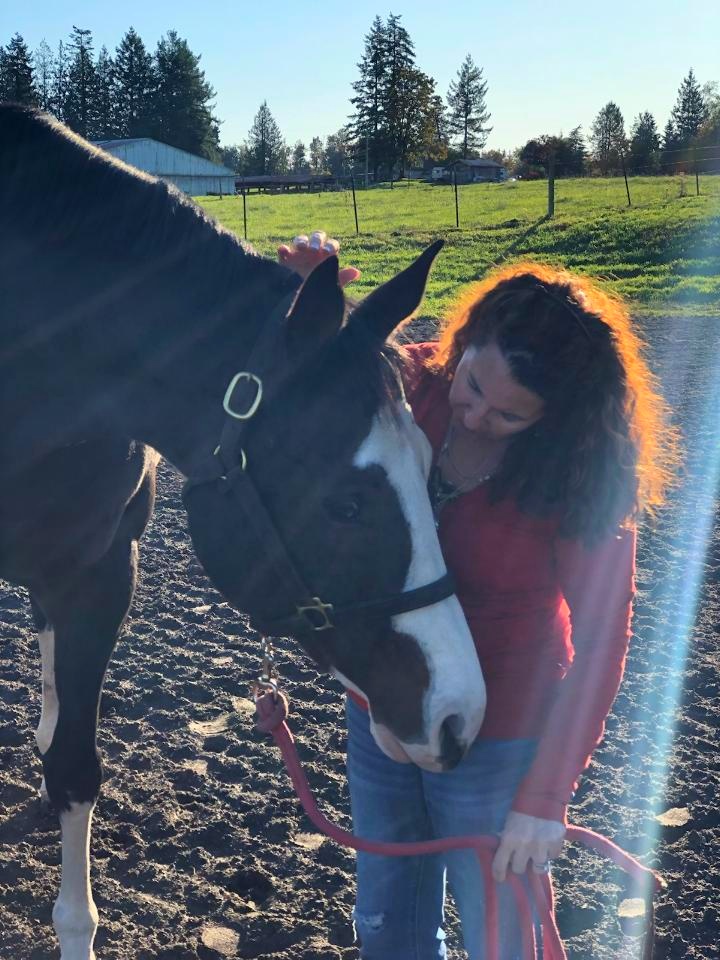Marie Matteson with a horse, practicing equine communication