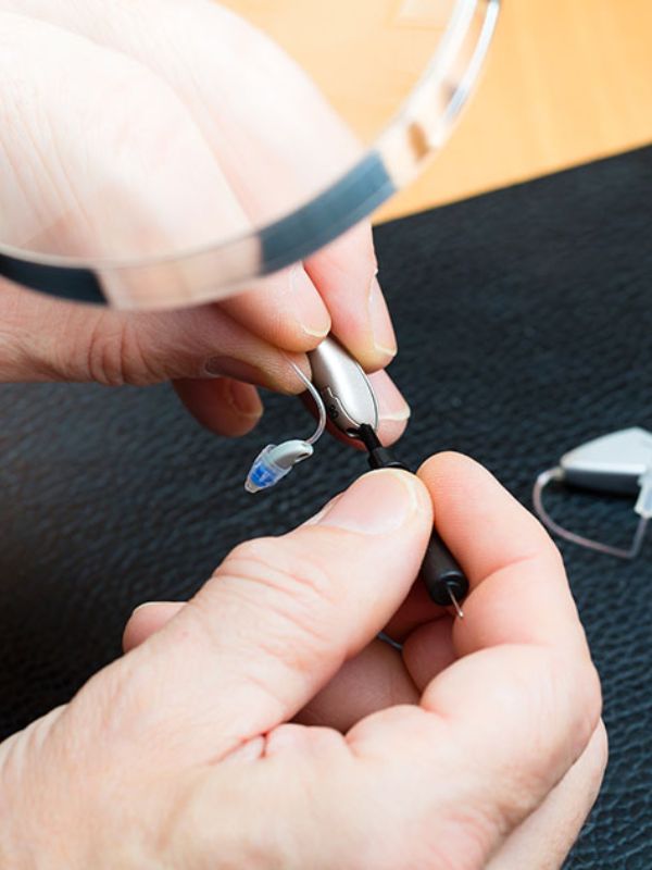 close up of a hearing aid being repaired