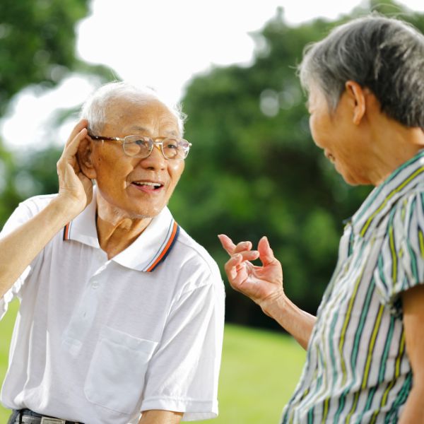 man holding his hand to his ear