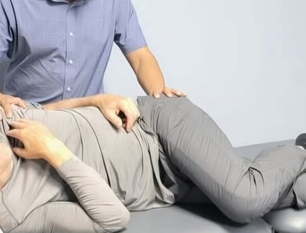 Physiotherapist assessing and treating lower back pain at Medhealth Physiotherapy in Hamilton