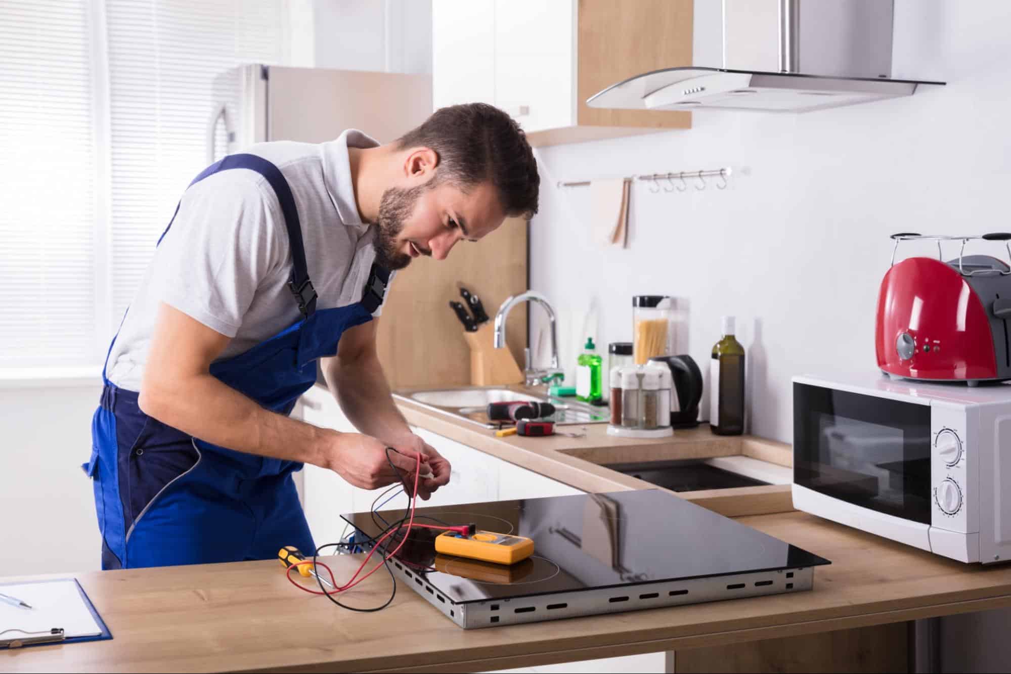 Technician performing stove and oven maintenance