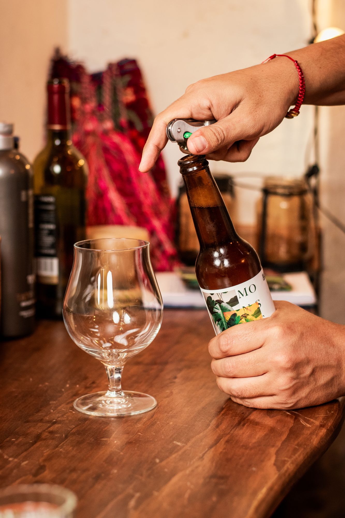 Opening a bottle of Mexican craft beer next to an empty tulip glass