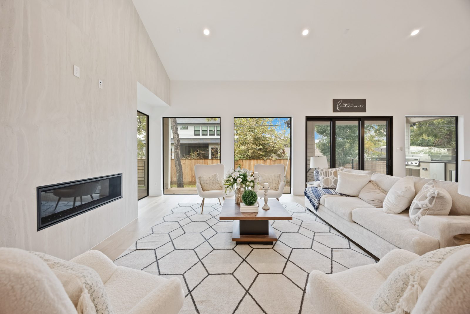 Bright living room with a linear fireplace and large windows