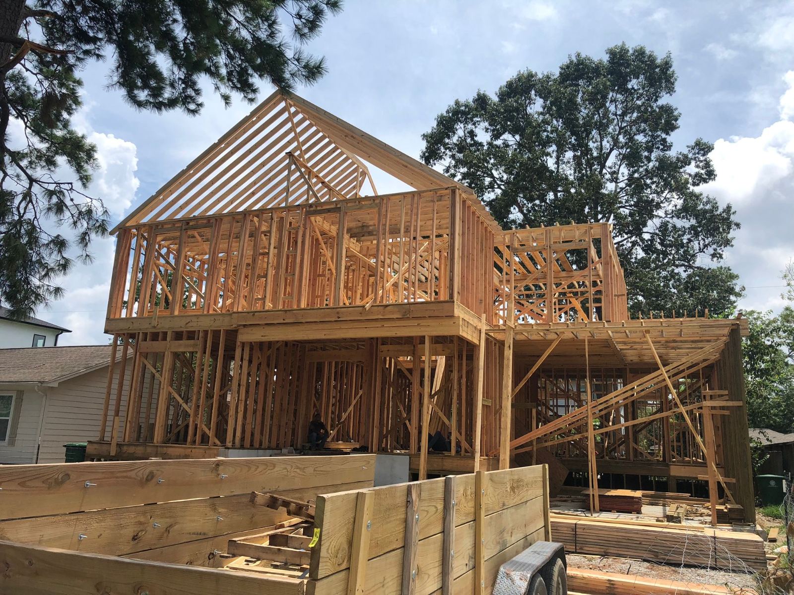 Two-story home under construction with exposed wood framing