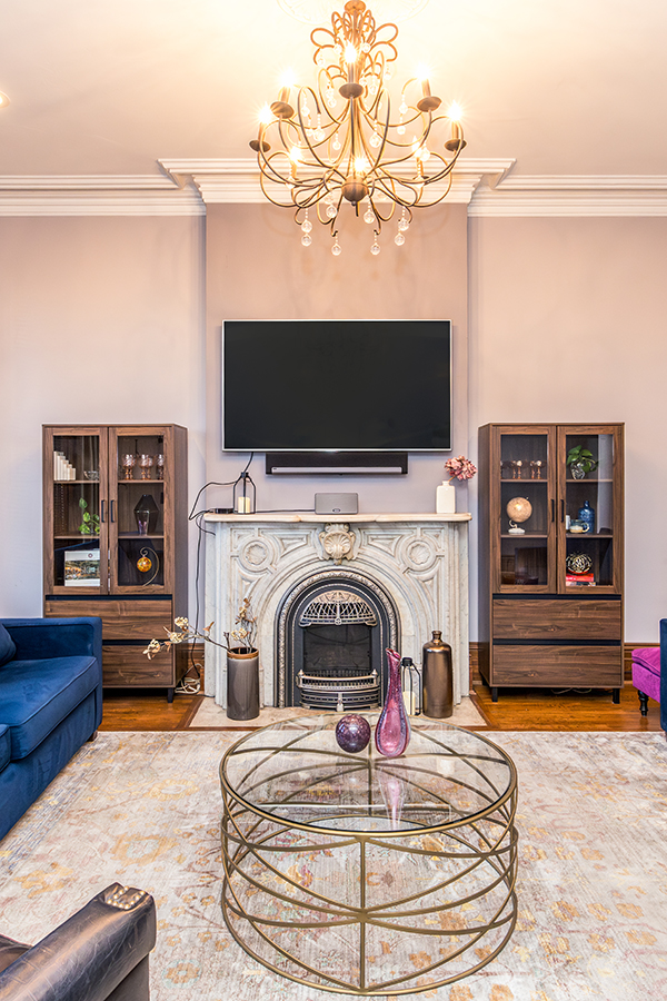 woman setting sheets on bed