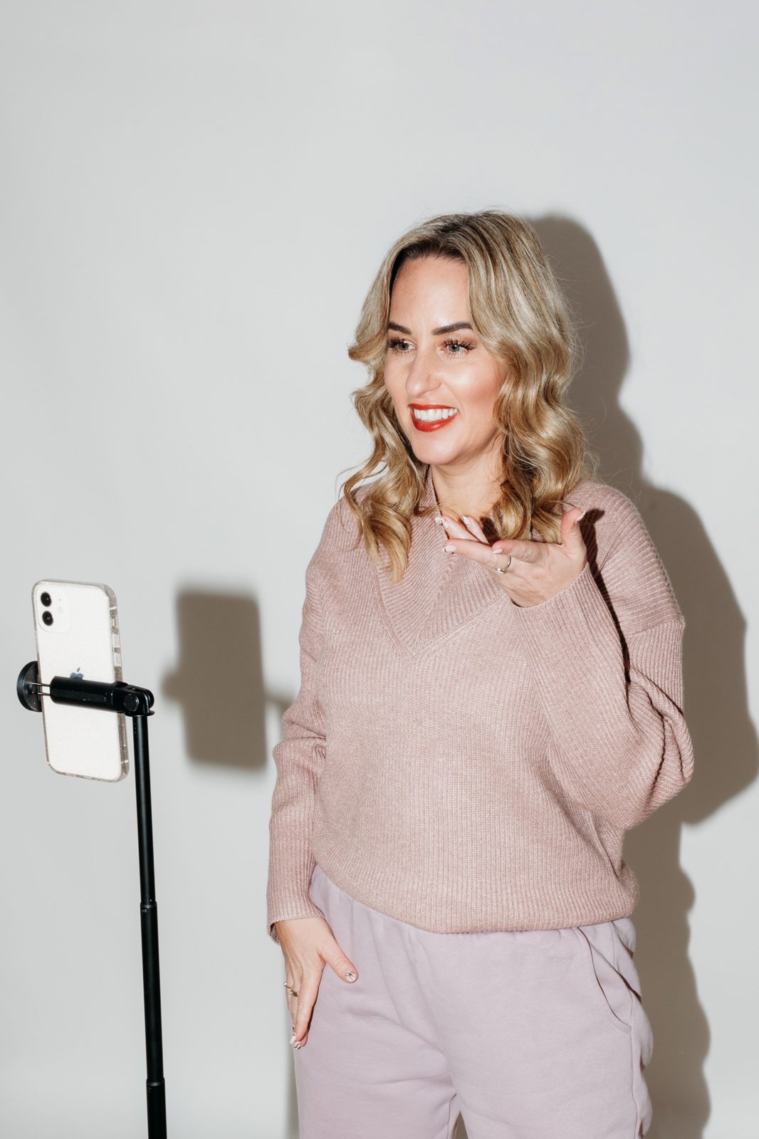 Gemma Heard in a pink jumper, talking to camera