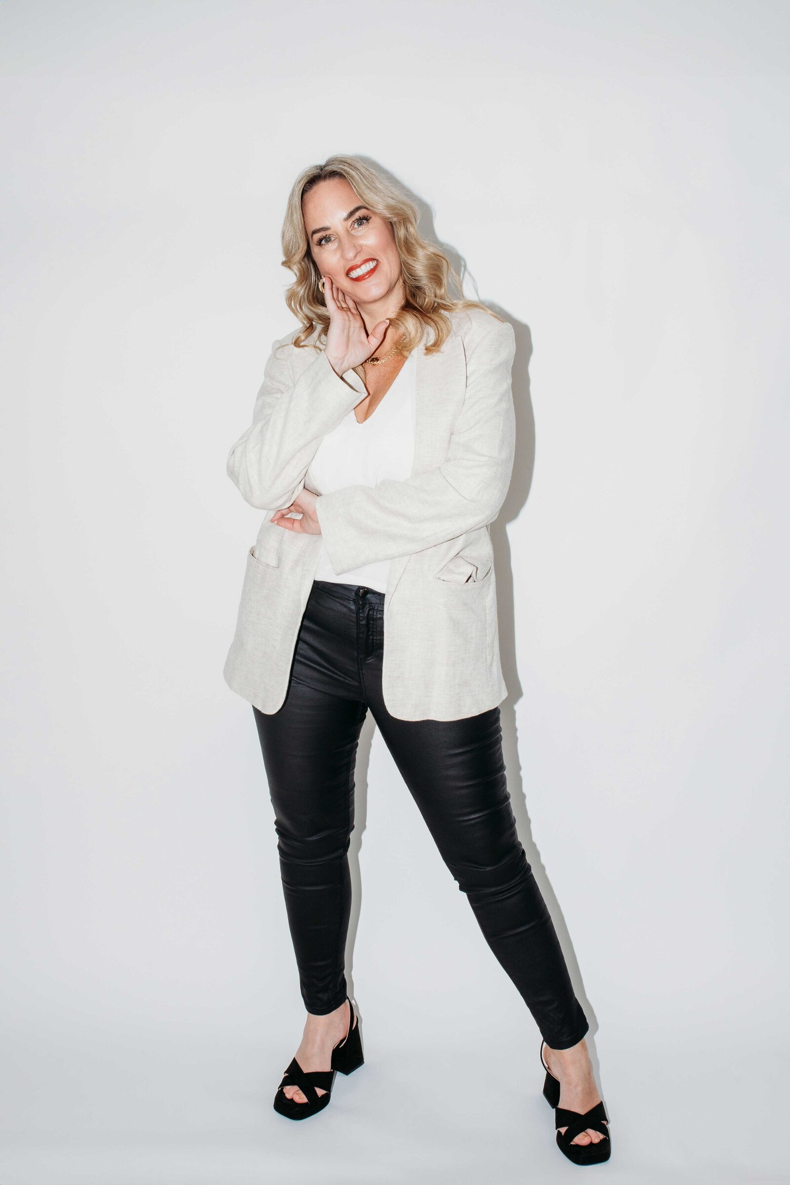 Gemma Heard in a cream blazer, smiling