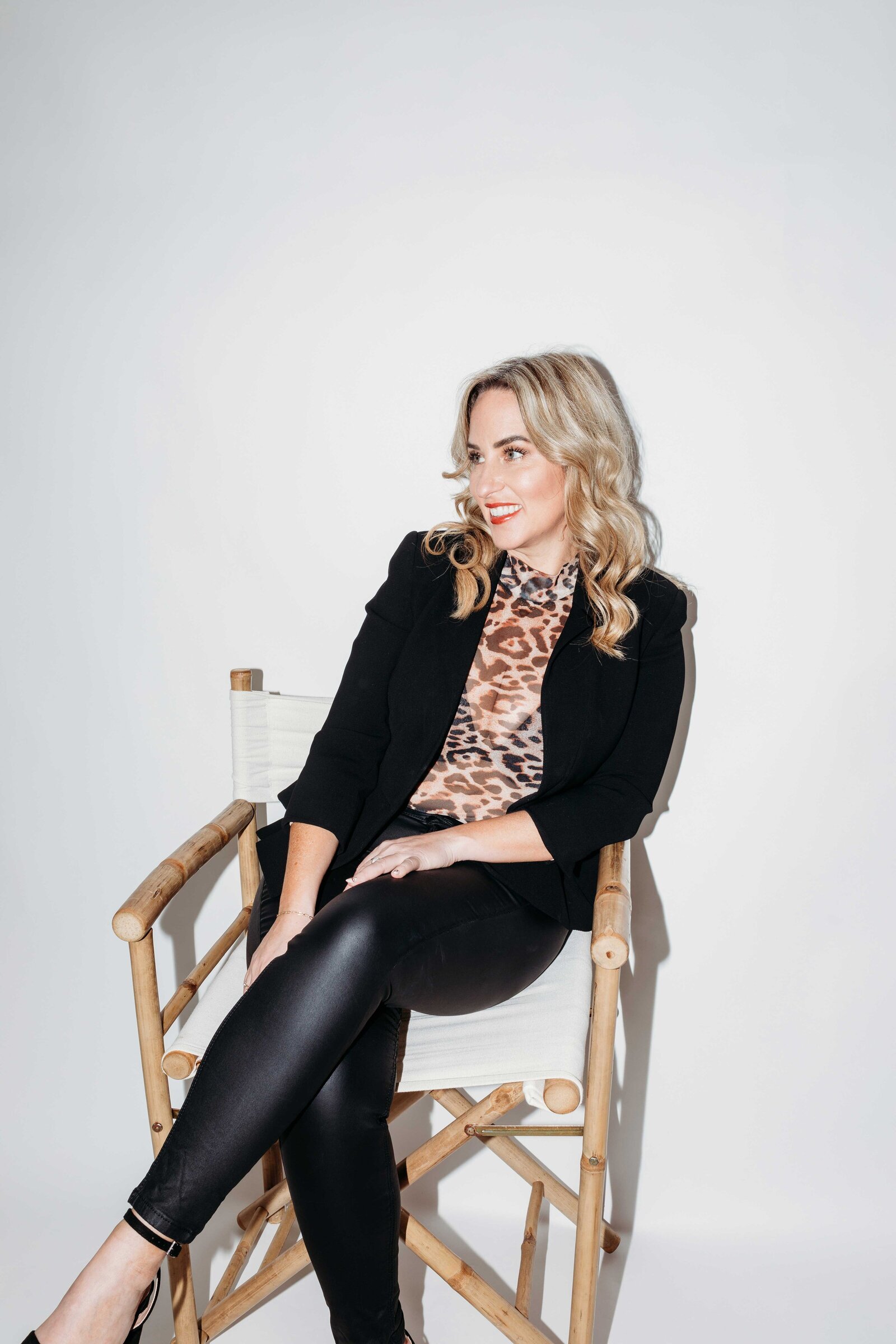 Gemma Heard smiling, sitting in a director's chair