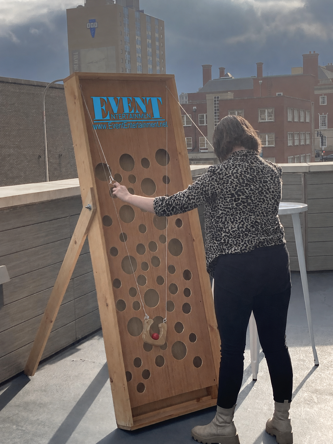 Giant Holey Moley interactive wooden game with an upright board, rows of holes, and a suspended ball holder.