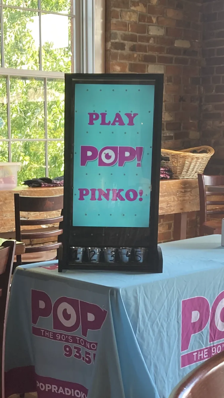 Pop 93.5 radio promotional tabletop game featuring a Play Pop Pinko board at an indoor event