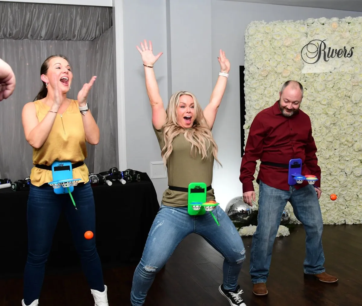 Adults laughing and playing Walla Balla, an interactive group game for parties and corporate events.