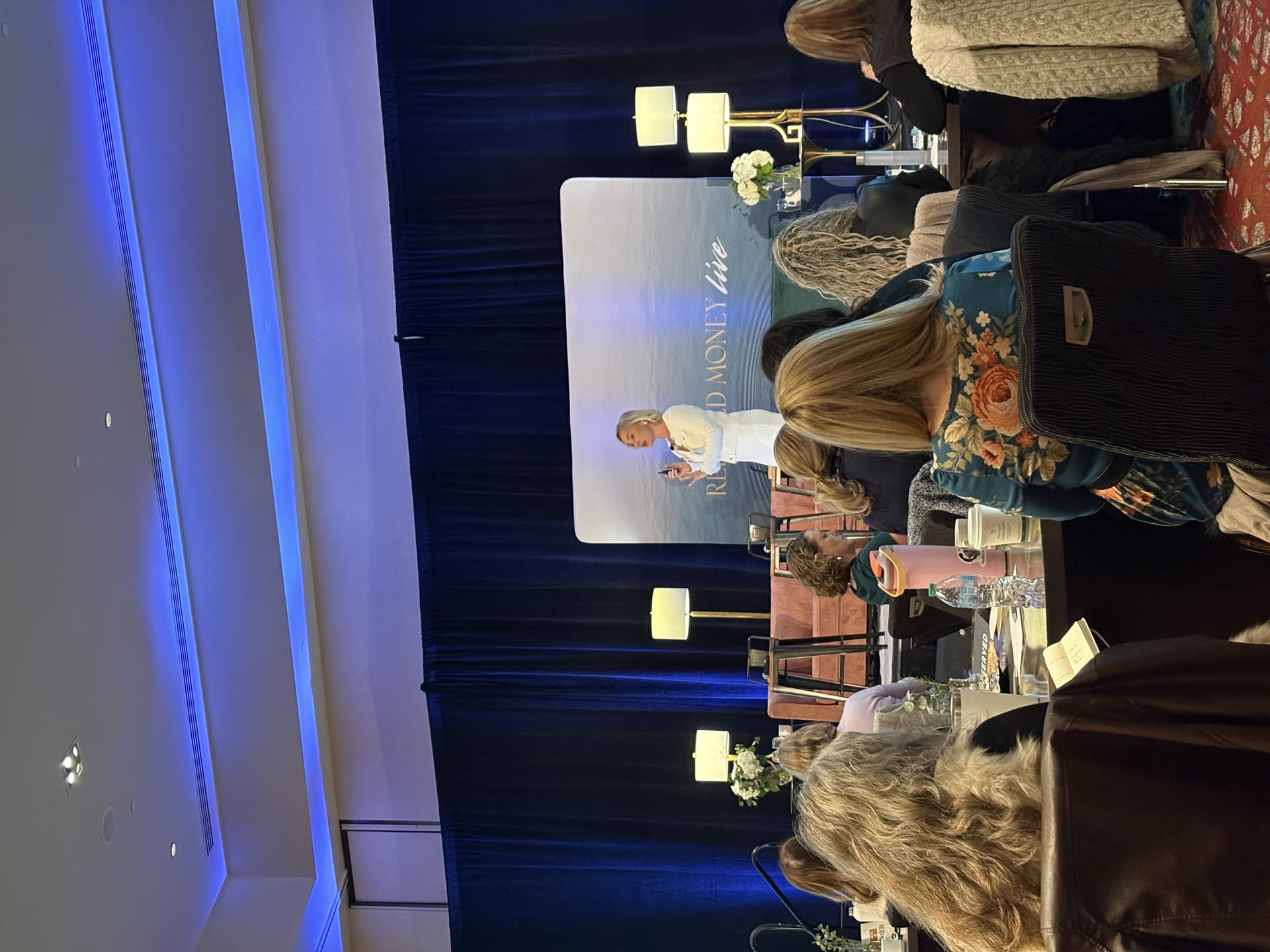 Kate Northrup presenting at the Relaxed Money Live event on stage in front of an audience, discussing money mindset and sustainable wealth.