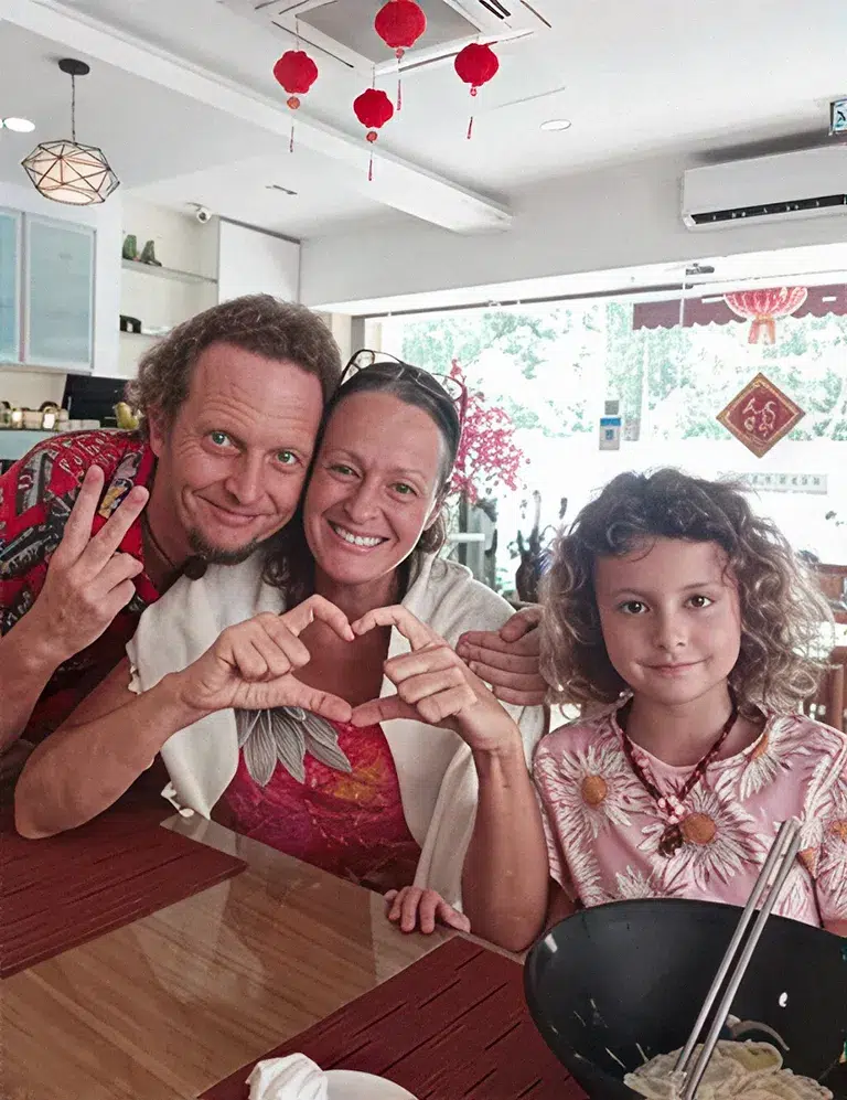 A family making a heart sign at their table