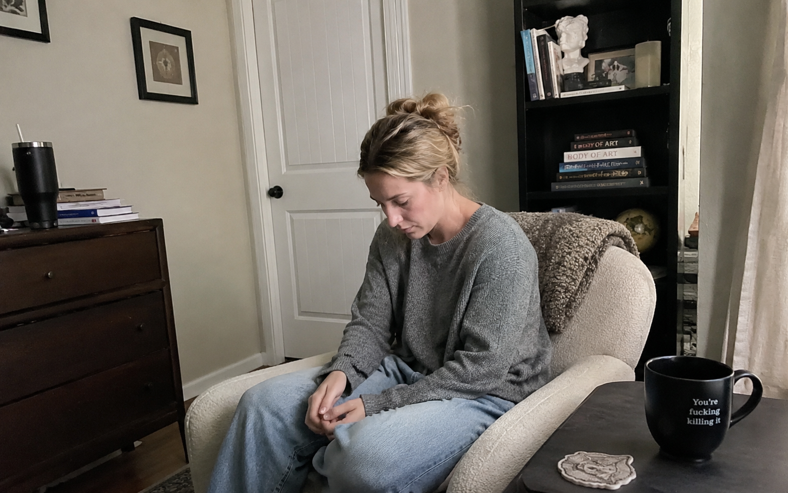 Woman sitting quietly looking at her hands — the identity loss and grief that comes with burnout recovery for high-achieving women" Woman sitting quietly looking at her hands — the identity loss and grief that comes with burnout recovery for high-achieving women"