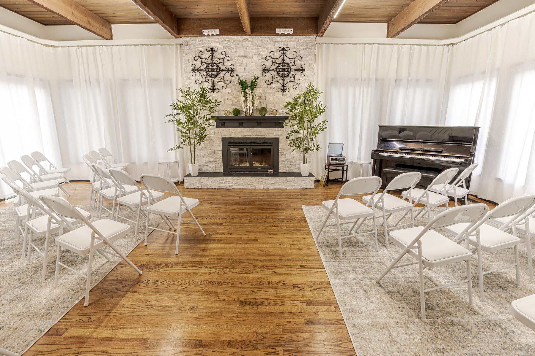 Chairs set in rows by the fireplace at Jones Landing