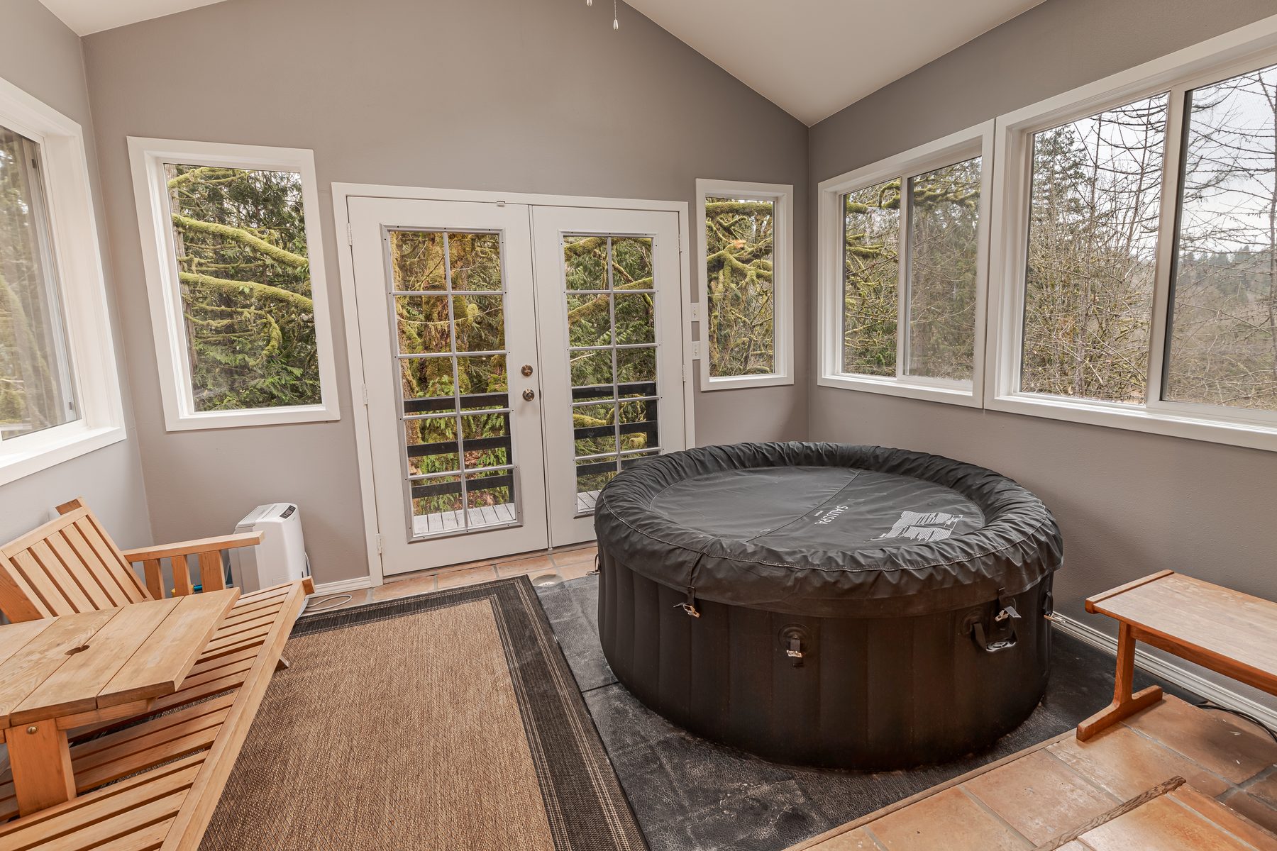 Sunroom with a hot tub at Jones Landing