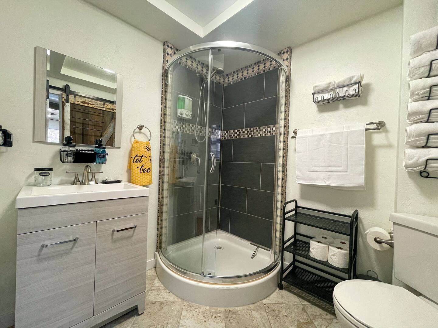 Unit 2 bathroom after, with a corner shower