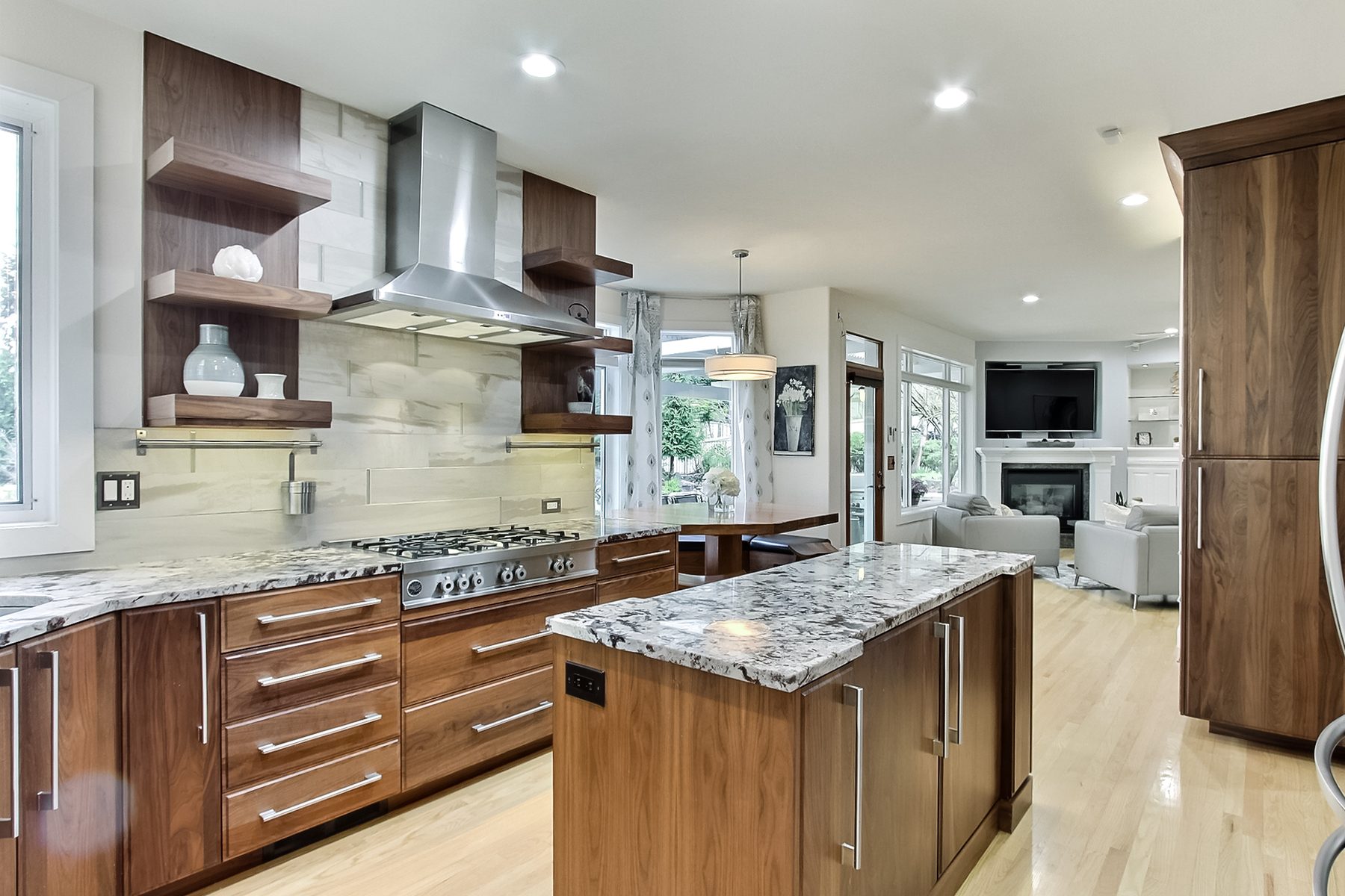 Finished kitchen range wall and island, open to the family room