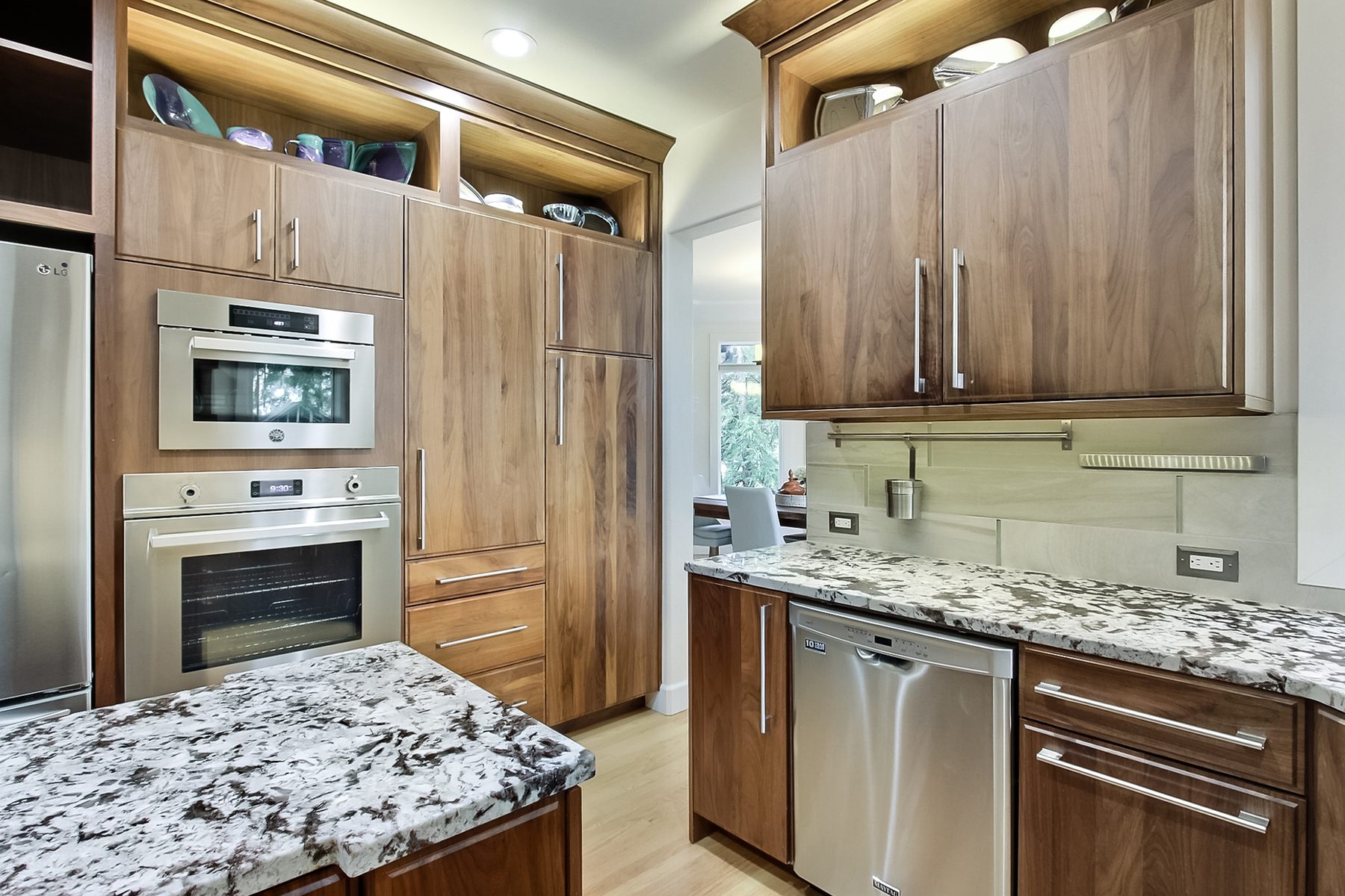 Finished kitchen with wall ovens and built-in cabinets