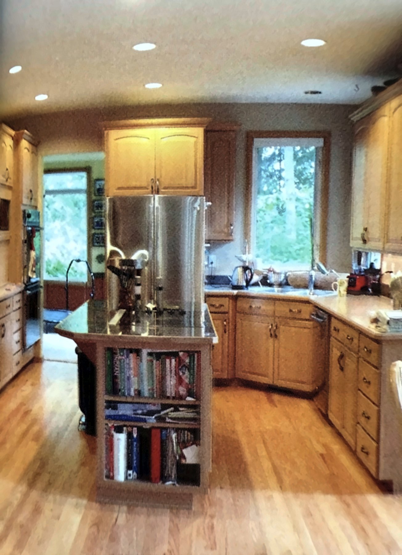 Kitchen remodel before, original island with a bookshelf end