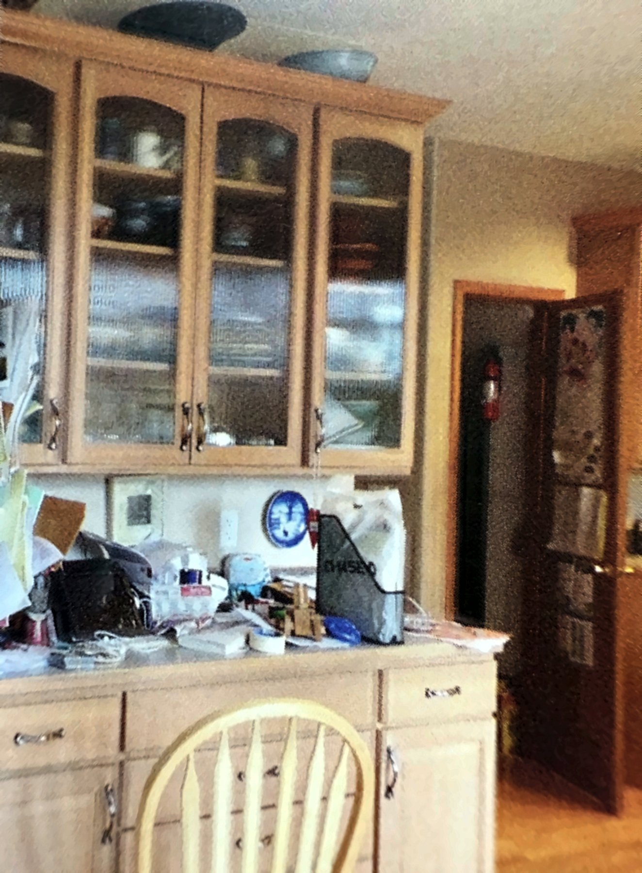 Kitchen remodel before, original glass-front cabinet and counter
