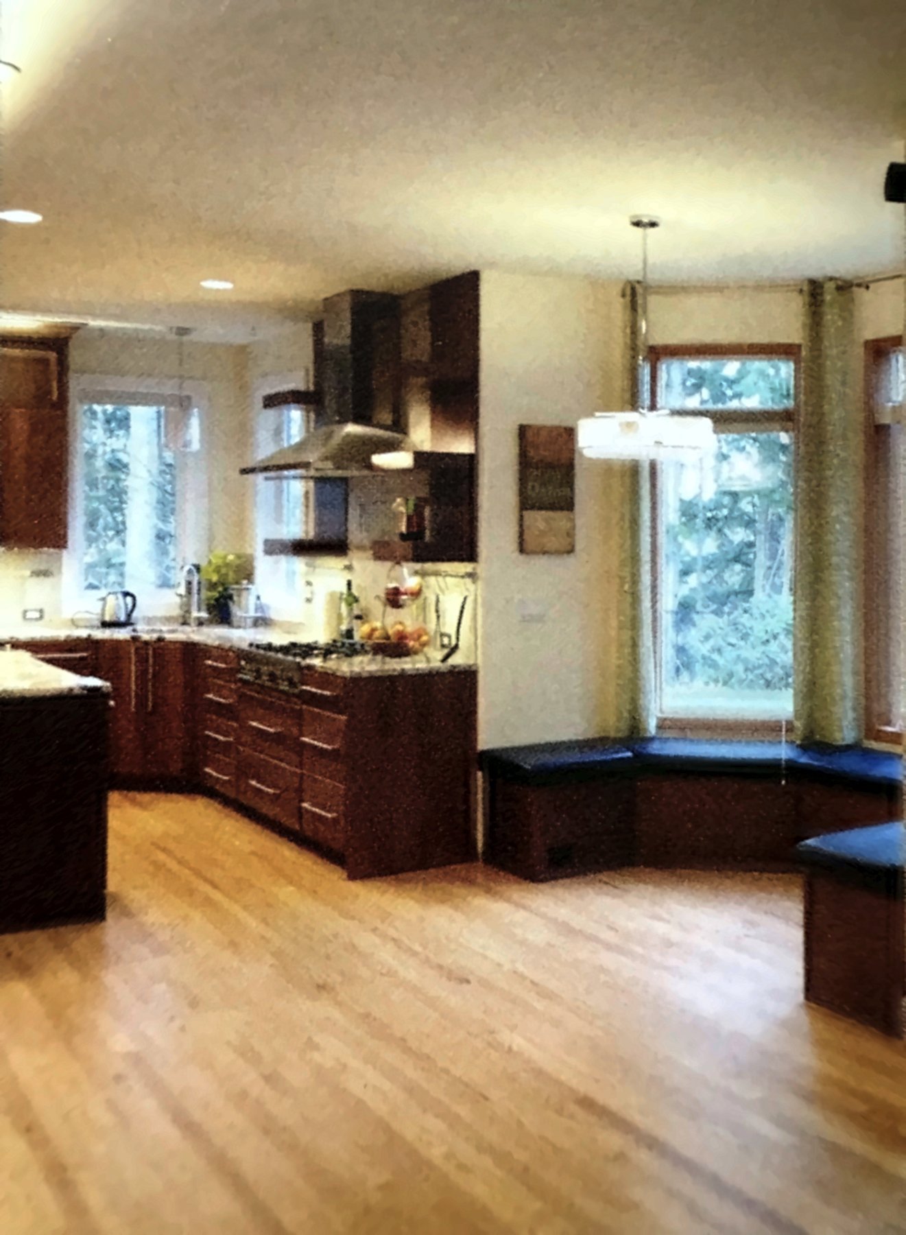 Finished kitchen seen from the eating nook with a window bench