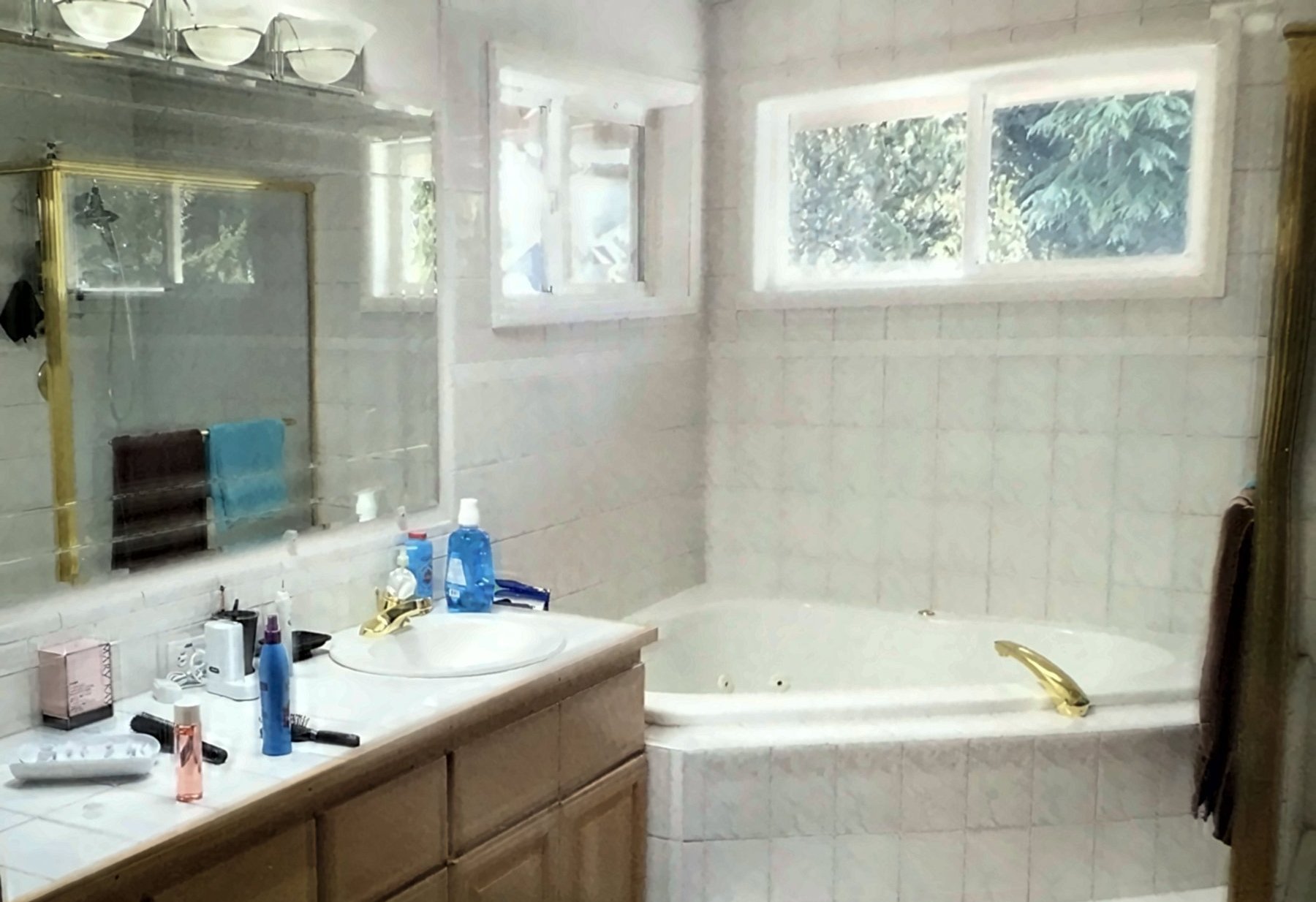 Master bathroom before the remodel, with a corner jetted tub and a single vanity