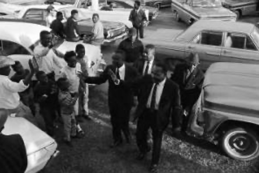 Dr. Martin Luther King Jr., William M. Branch and Ralph Abernathy greeting people outside First Baptist Church in Eutaw, Alabama, December 1965