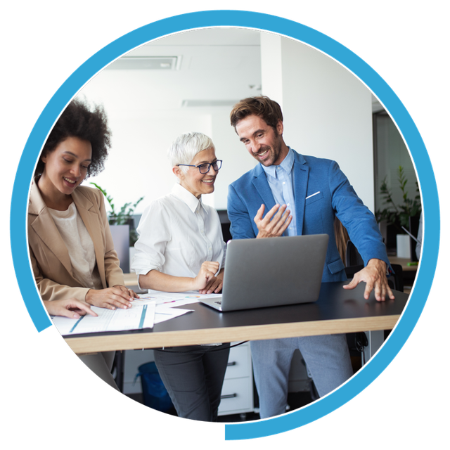 A leadership team reviewing a plan together at a laptop
