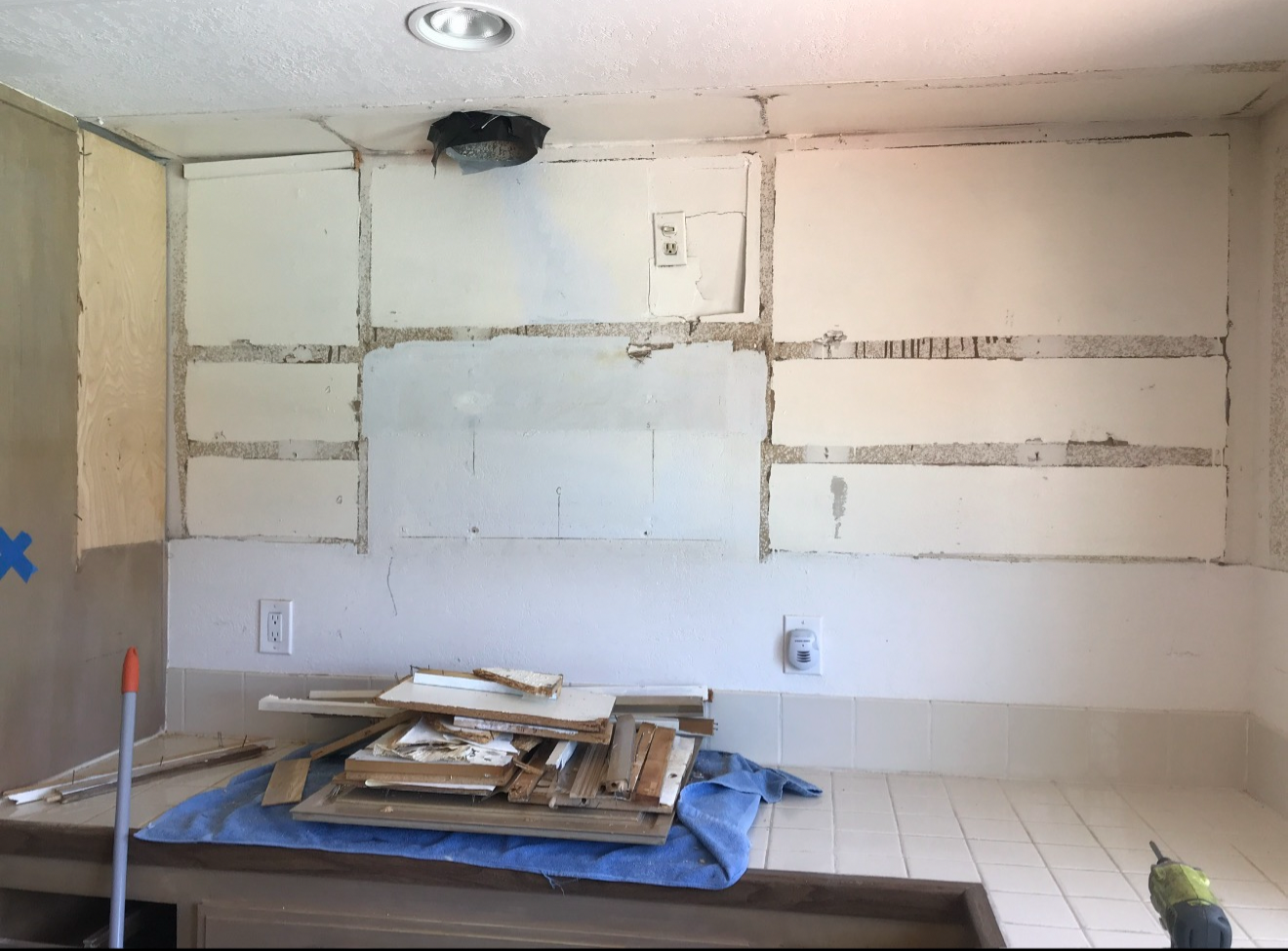 Kitchen wall after demolition of backsplash and upper cabinets