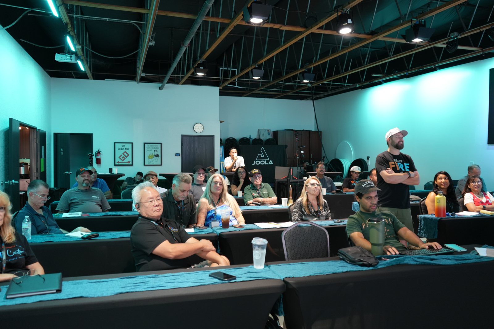 A full Deal Room on a Wednesday at the FIRE Center, Rich Rice standing at the side