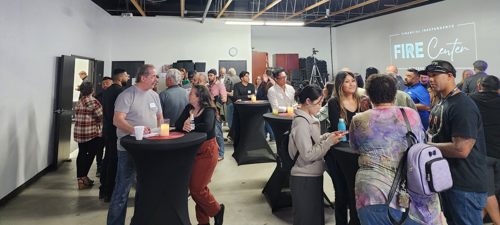 Investors talking at high-top tables at the FIRE Center