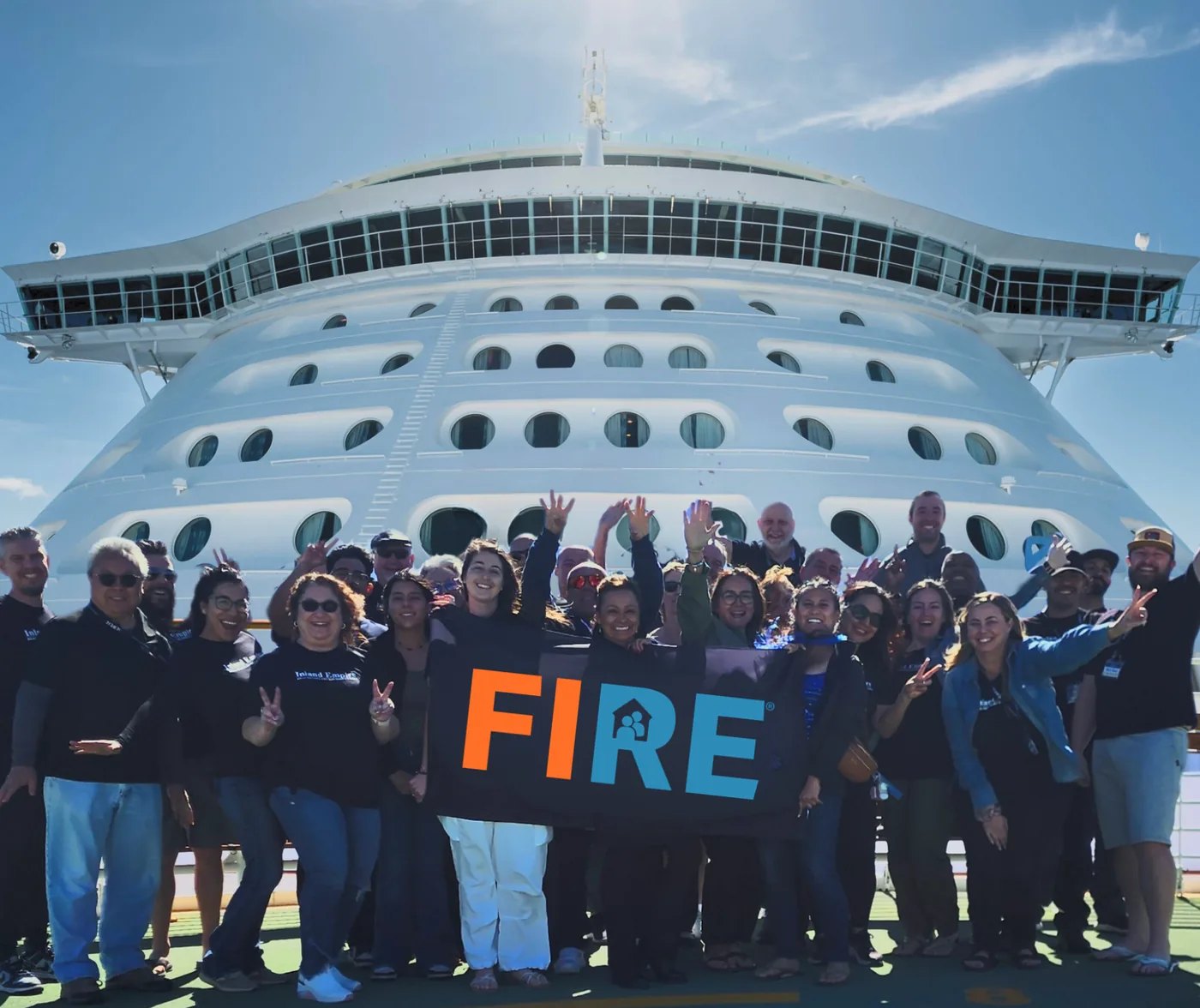 FIRE Center group holding a FIRE banner on a cruise ship