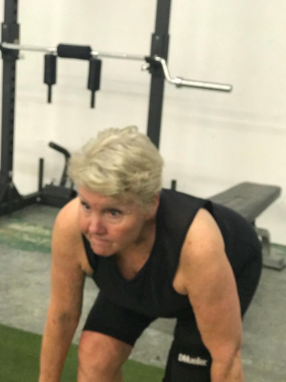 A client working through a strength movement on the iRISE training turf