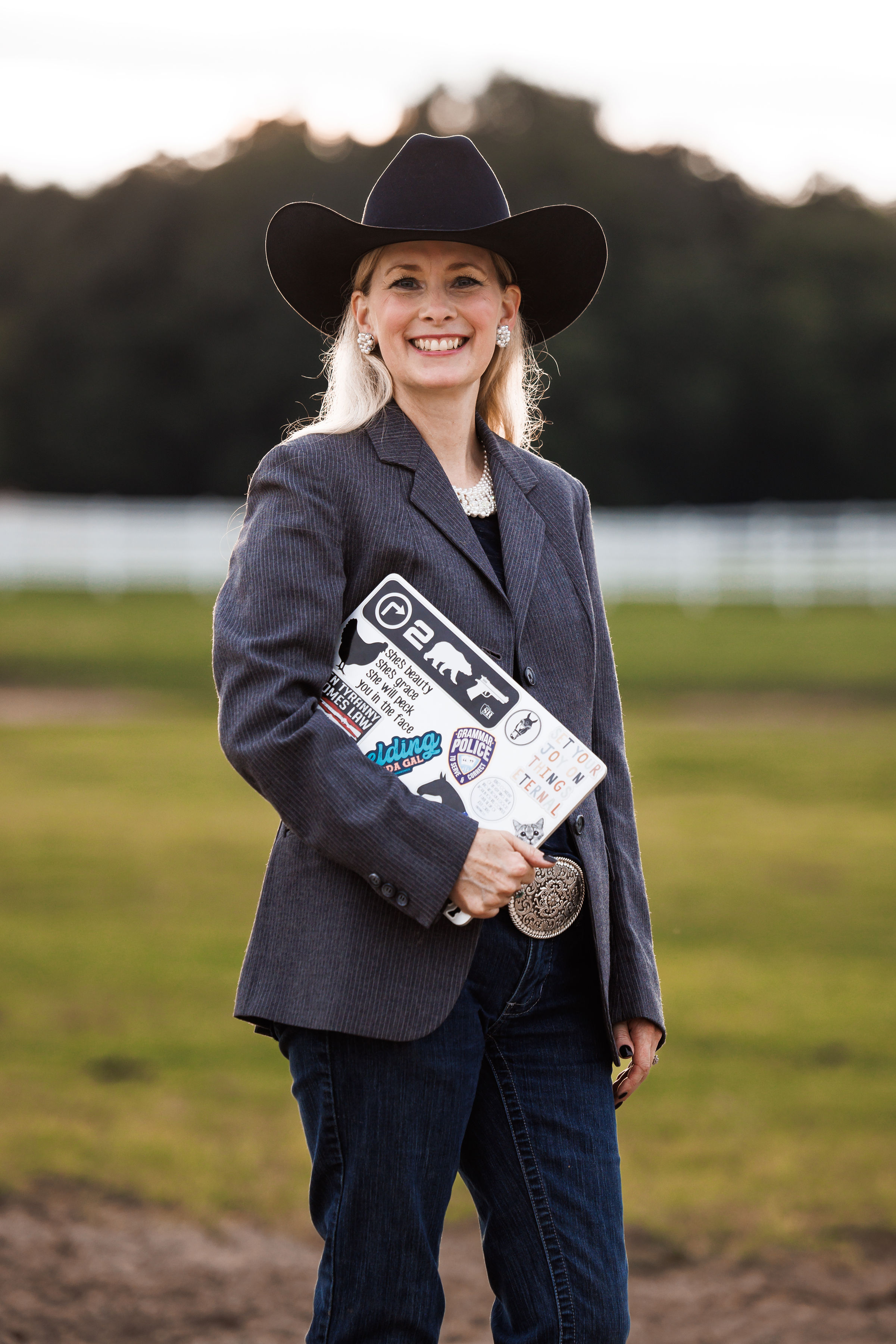 Jamie holding her laptop at the farm