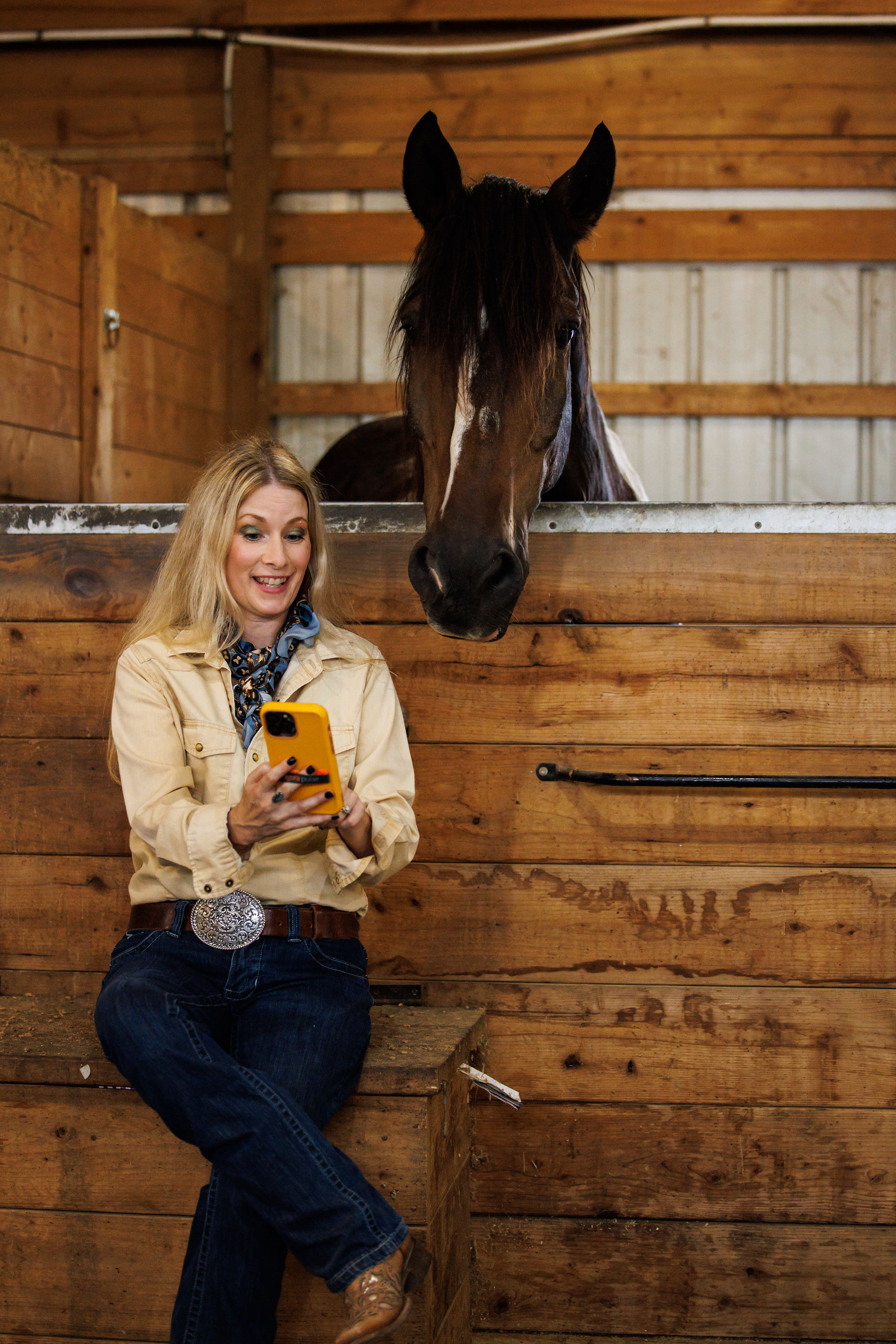Jamie reviewing content on her phone at the barn