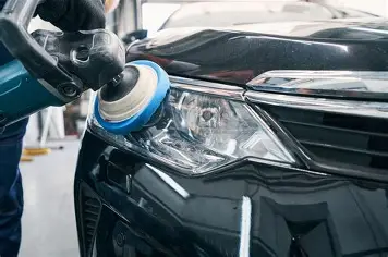 Restored clear headlight next to a cloudy yellowed one