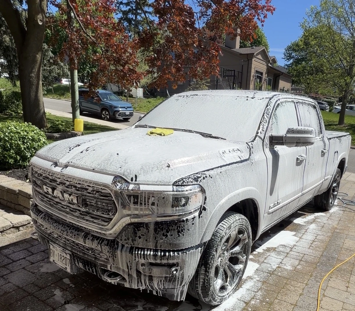 Pickup truck covered in cleaning foam during a hand wash in Toronto