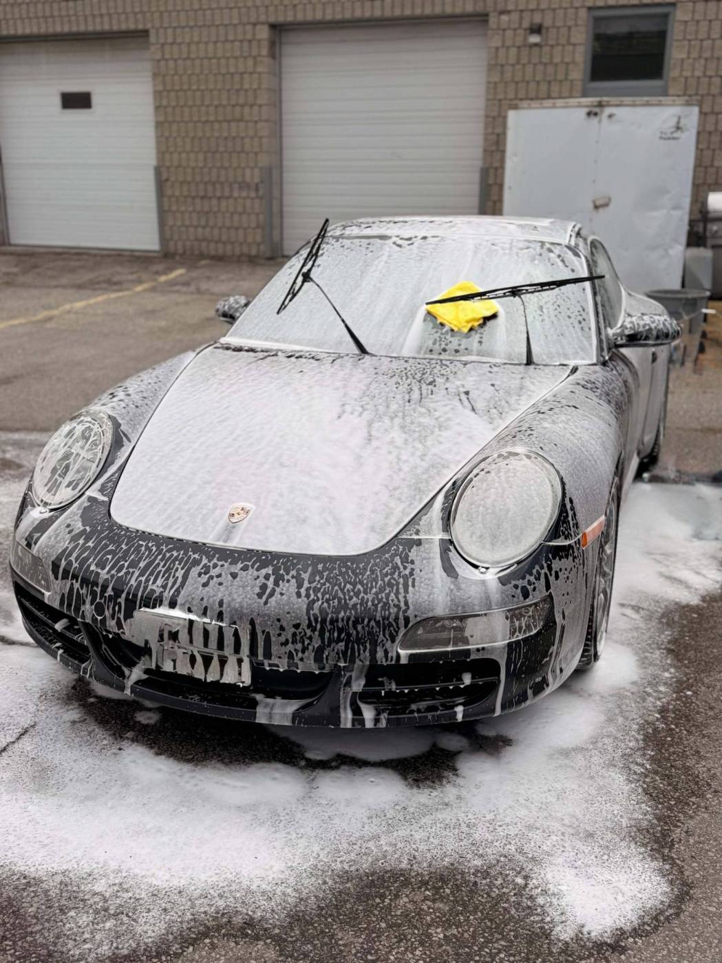 Pickup truck covered in cleaning foam during a hand wash