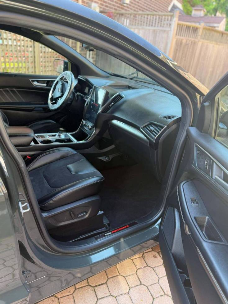 Clean vehicle interior with spotless seats and carpet after standard detailing